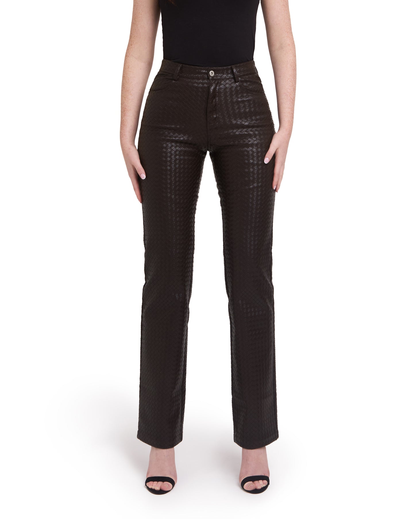A pair of tall woven leather trousers in deep brown color, with a straight leg design. The trousers are modeled by a person standing against a plain background.