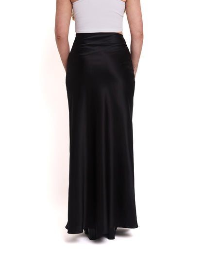 A model wearing a tall, high-waisted, tailored black maxi skirt with a high waist and invisible side zip. Back shot