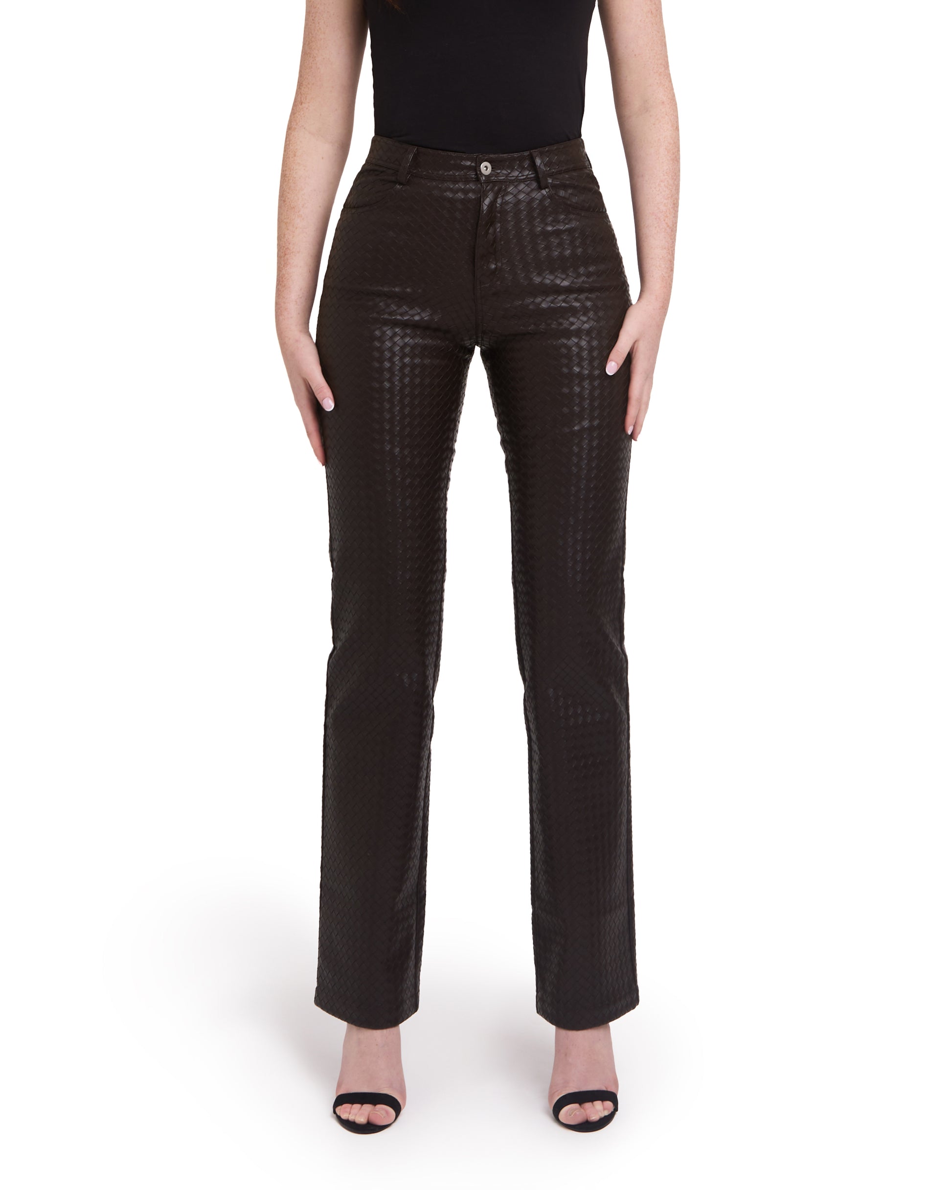 A pair of tall woven leather trousers in deep brown color, with a straight leg design. The trousers are modeled by a person standing against a plain background.