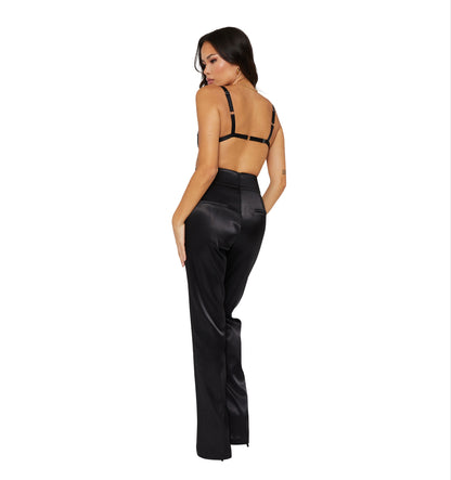 A Tall model wearing high waisted satin trousers with a straight leg cut, featuring a back zip and hook closure, and leg zip detailing. standing to the back with two pockets at the back.