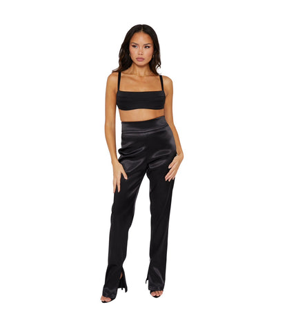 A Tall model wearing high waisted satin trousers with a straight leg cut, featuring a back zip and hook closure, and leg zip detailing.