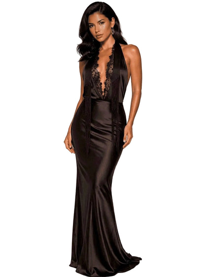 Woman wearing a black evening gown with lace detailing on a plain background- tall woman 